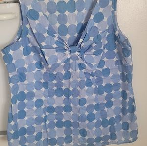 Cato top runs small, periwinkle poka dot top, fitted and with bow detail.
